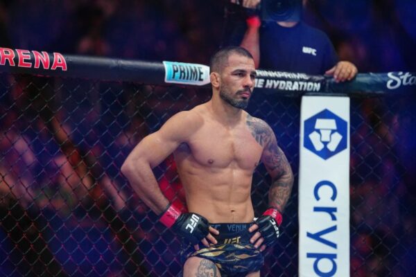 O lutador do UFC Alexandre Pantoja no octógono, com as mãos na cintura e expressão séria.