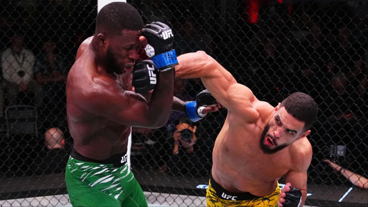 UFC fighter Gabriel Bonfim lands a hard right punch on Randy Brown's head during their fight in the octagon.