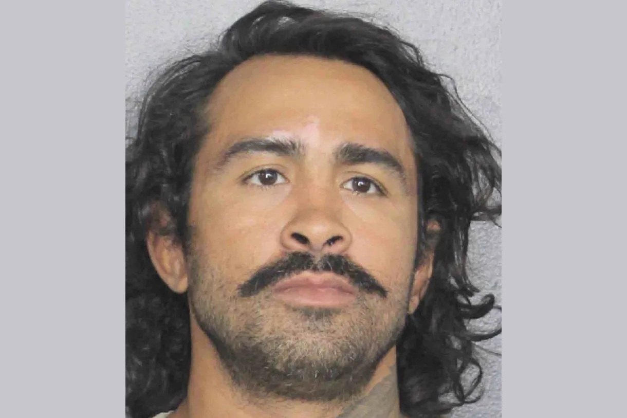 Mugshot of MMA fighter Godofredo "Pepey" Castro with long dark hair, a mustache, and a neutral expression.